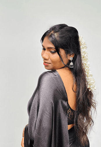 Duvini in profile with jasmine flowers in her hair